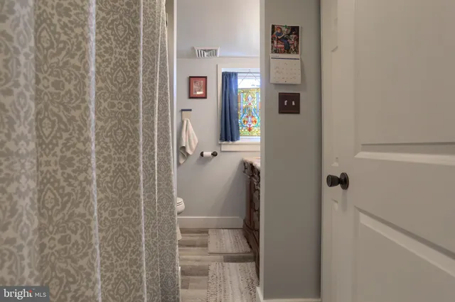 a bathroom with a granite countertop shower