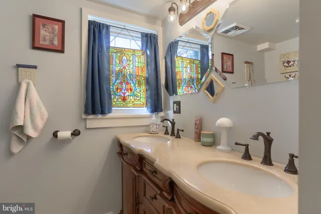 a bathroom with sinks and a mirror