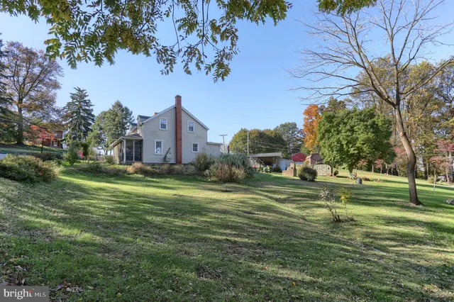 a front view of a house with a yard and trees