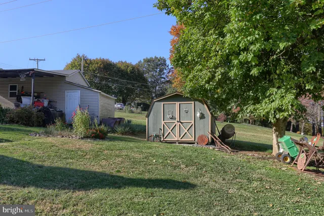 a view of a park with slide and a bench