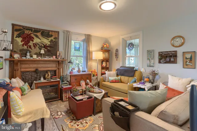 a living room with furniture a fireplace and a large window