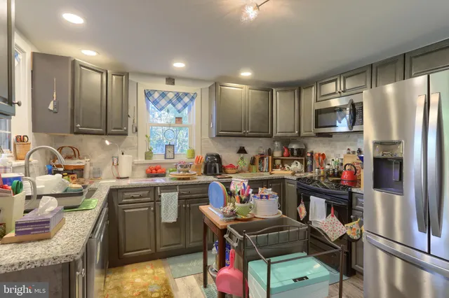 a kitchen with lots of appliances and wooden cabinets