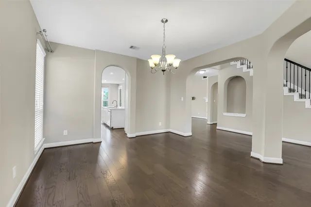 a living room with furniture a window and a flat screen tv