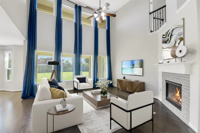 a view of an empty room with wooden floor a ceiling fan