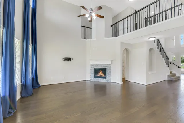 a view of an entryway with wooden floor and a kitchen