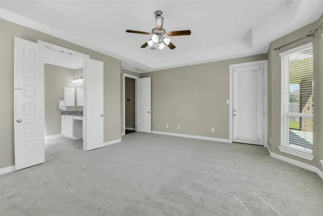 a bathroom with a granite countertop sink a toilet and shower