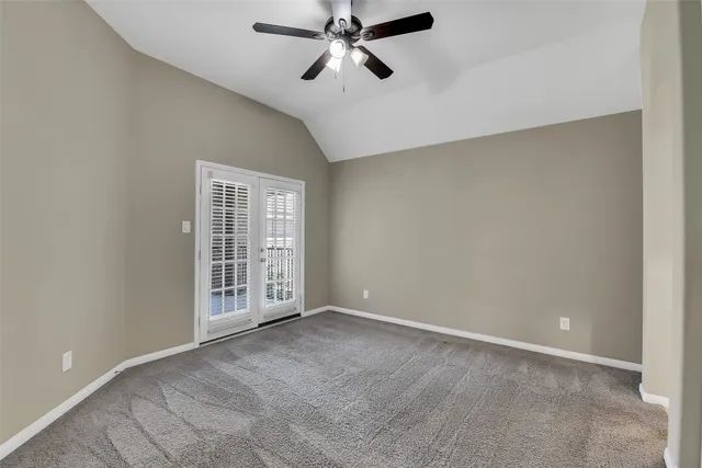 a view of an empty room with a ceiling fan