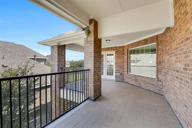 a view of a house with a big yard and potted plants