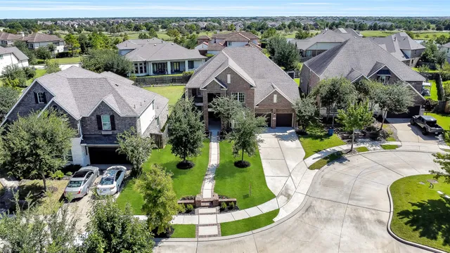 an aerial view of a house with a yard and lake view