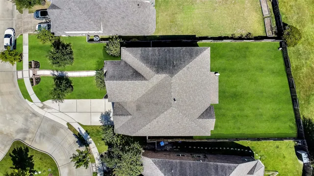 an aerial view of a house with garden space and street view