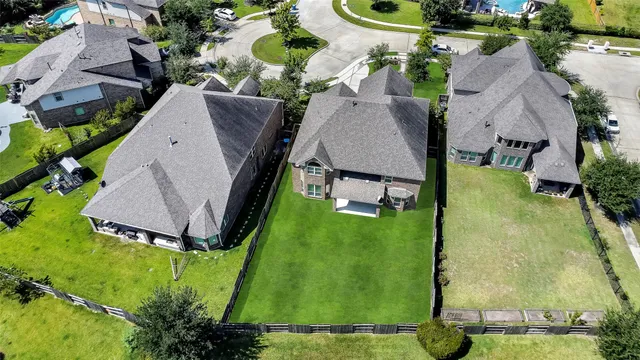 an aerial view of a house with yard swimming pool and outdoor seating
