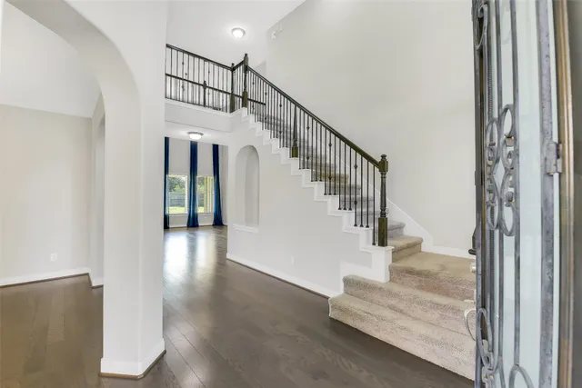 a view of entryway and hall with wooden floor