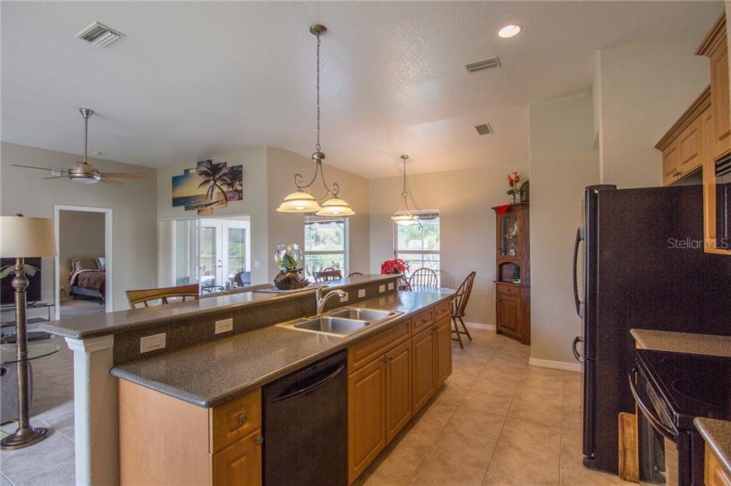 From kitchen looking at dining area and pool