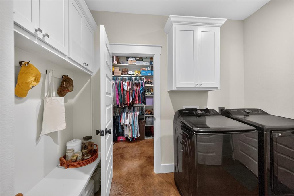 6371 Mill Run Road Athens, TX 75751 - Photo 24 of 40 Dedicated utility area featuring white shaker-style cabinetry, a built-in bench with storage, and a deep walk-in closet with custom shelving