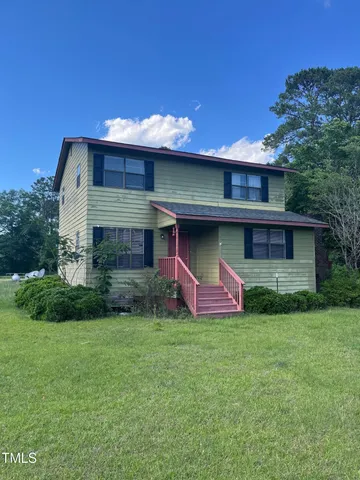a view of a house with a yard and a fireplace