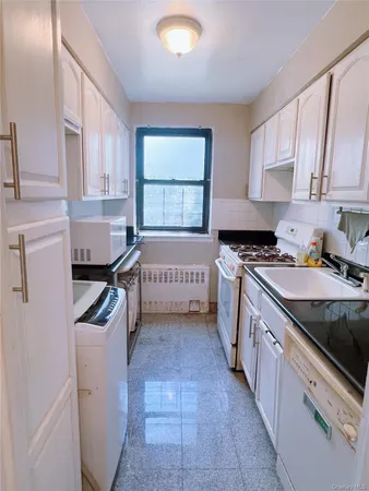 a kitchen with a sink a stove and cabinets
