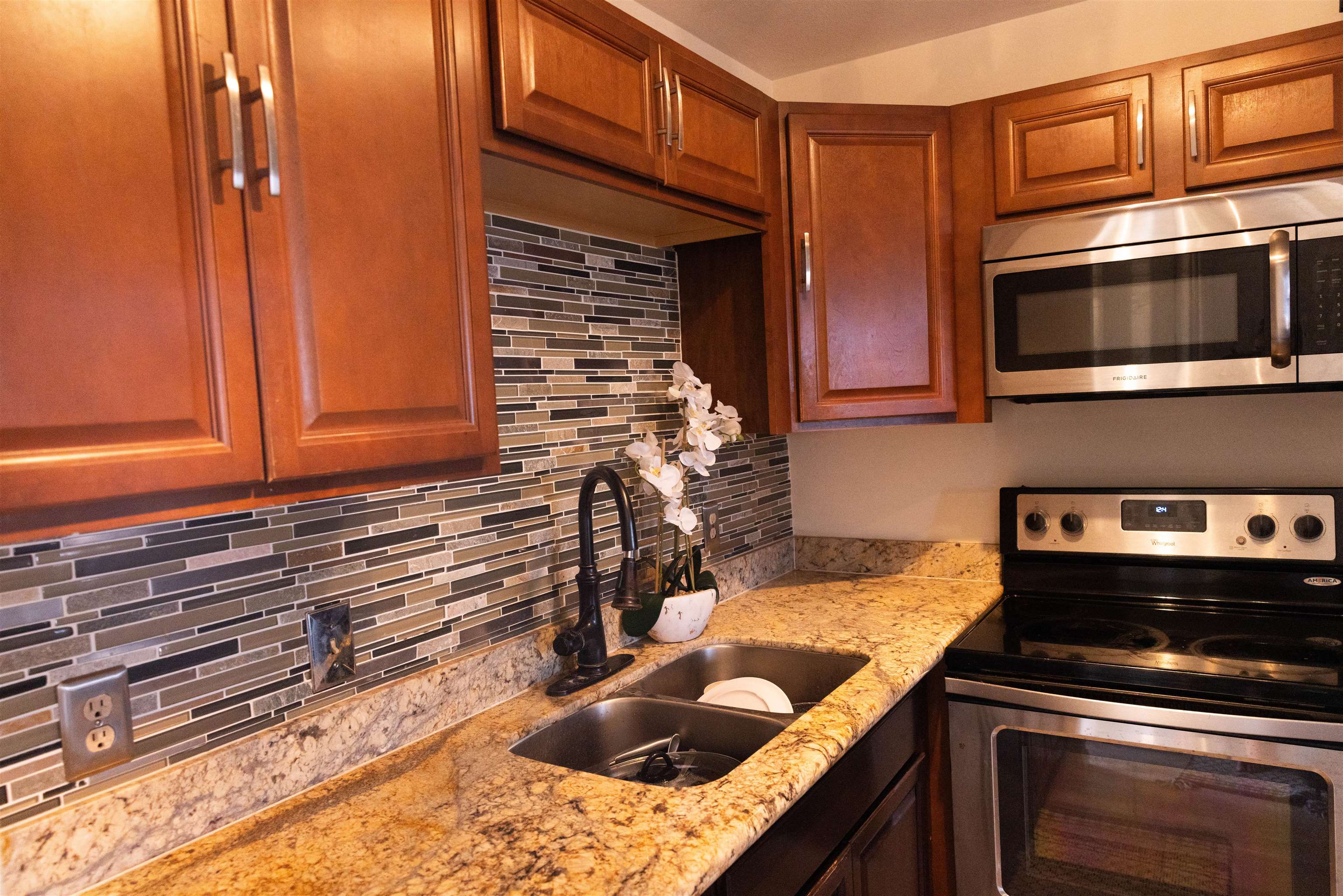 3740 Lower Honoapiilani Road, Unit G309 Lahaina, HI 96761 - Photo 3 of 17 a kitchen with stainless steel appliances granite countertop a sink stove and microwave