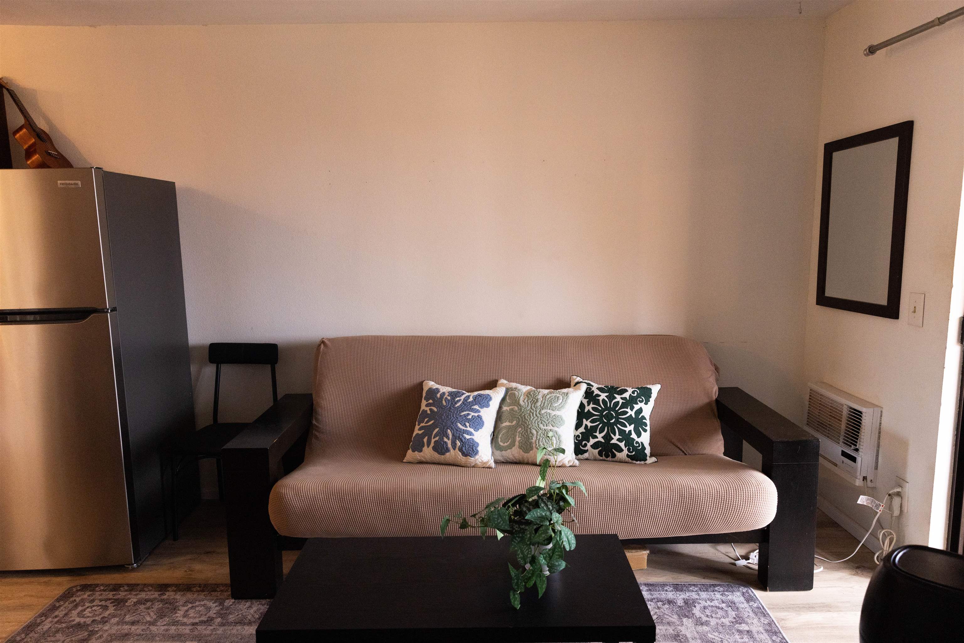 3740 Lower Honoapiilani Road, Unit G309 Lahaina, HI 96761 - Photo 6 of 17 a bed sitting in a bedroom next to a window with wooden floor