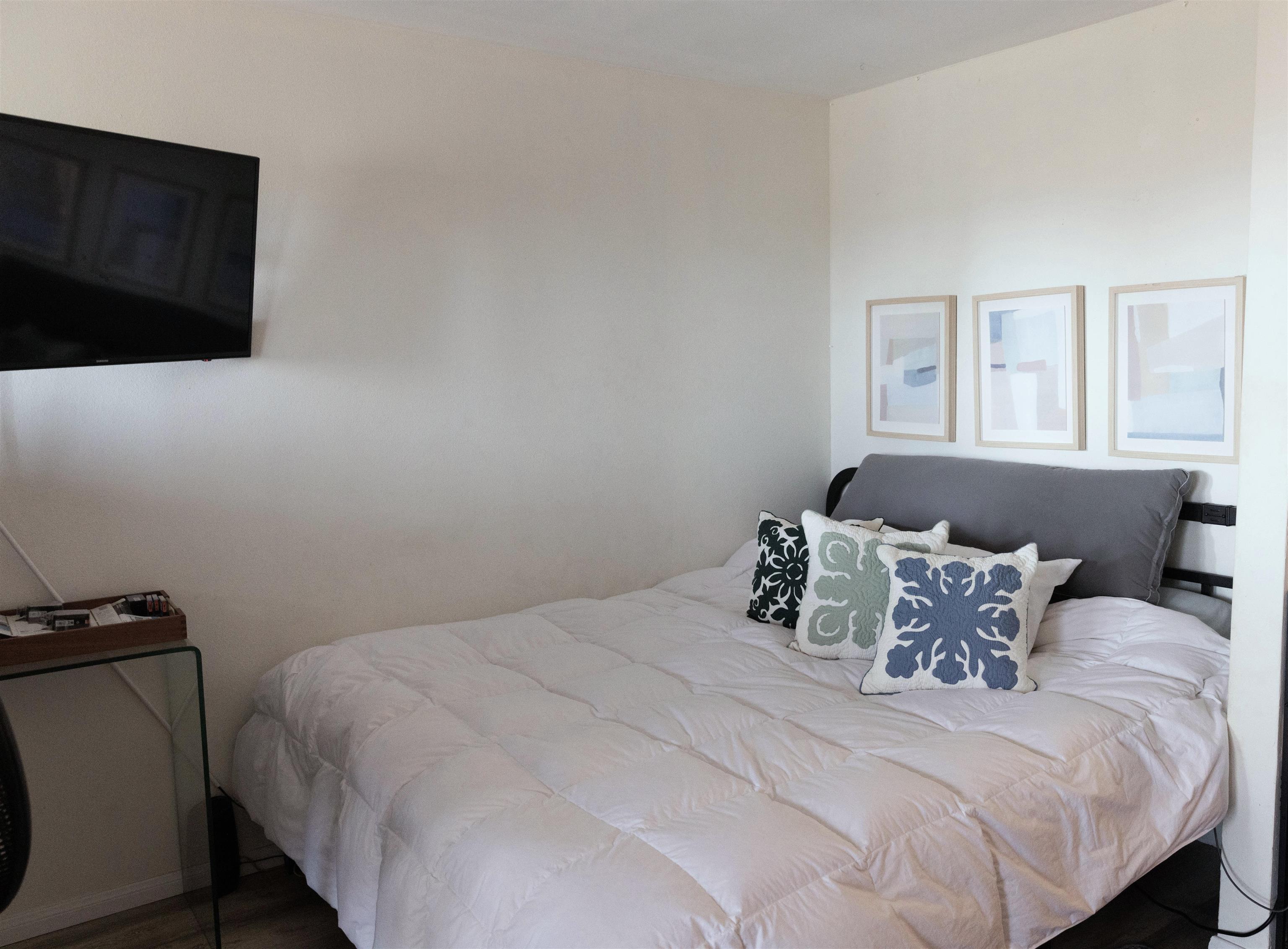 3740 Lower Honoapiilani Road, Unit G309 Lahaina, HI 96761 - Photo 7 of 17 a bedroom with a bed and wooden floor