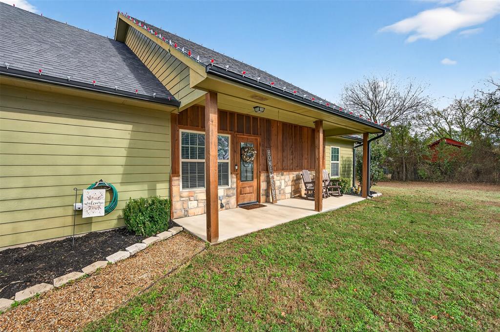 a view of a house with backyard and porch