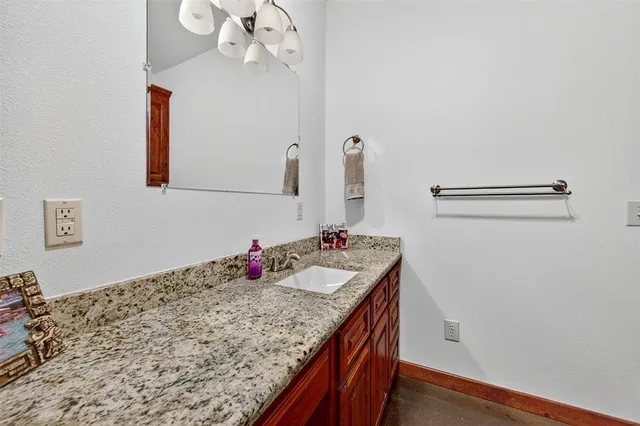 a bathroom with a sink vanity and granite