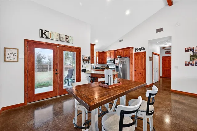 a dining room with furniture and wooden floor