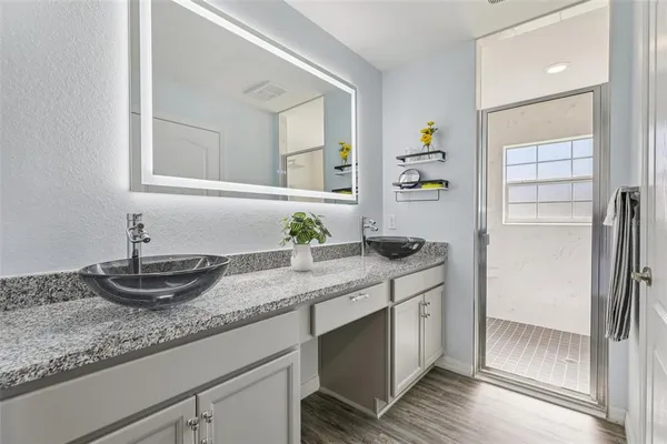 a kitchen with granite countertop a sink and cabinets