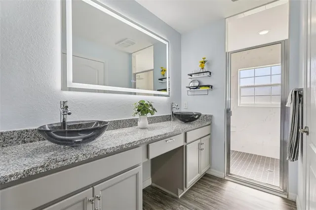a kitchen with granite countertop a sink and cabinets