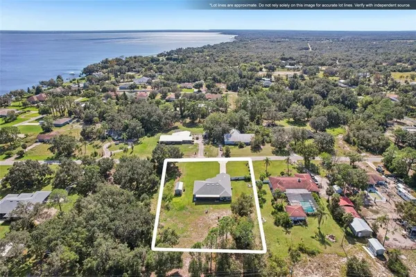 an aerial view of house with yard