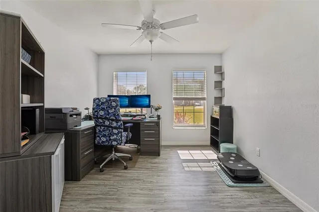 a view of a workspace with furniture and a window