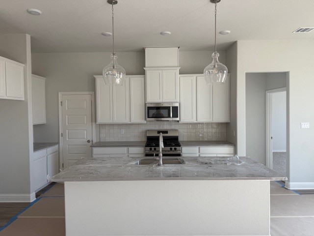 6422 Raleigh Loop College Station, TX 77845 - Photo 17 of 21 a kitchen with kitchen island a counter top space appliances and a counter top space
