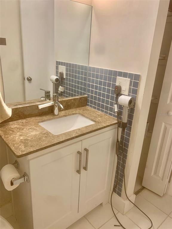 954 Lake Destiny Road, Unit E Altamonte Springs, FL 32714 - Photo 11 of 11 a bathroom with a granite countertop sink and a washing machine