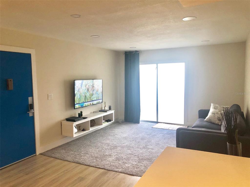 954 Lake Destiny Road, Unit E Altamonte Springs, FL 32714 - Photo 3 of 11 a living room with furniture window and wooden floor