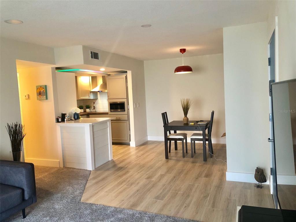 954 Lake Destiny Road, Unit E Altamonte Springs, FL 32714 - Photo 5 of 11 a living room with furniture a dining table and wooden floor