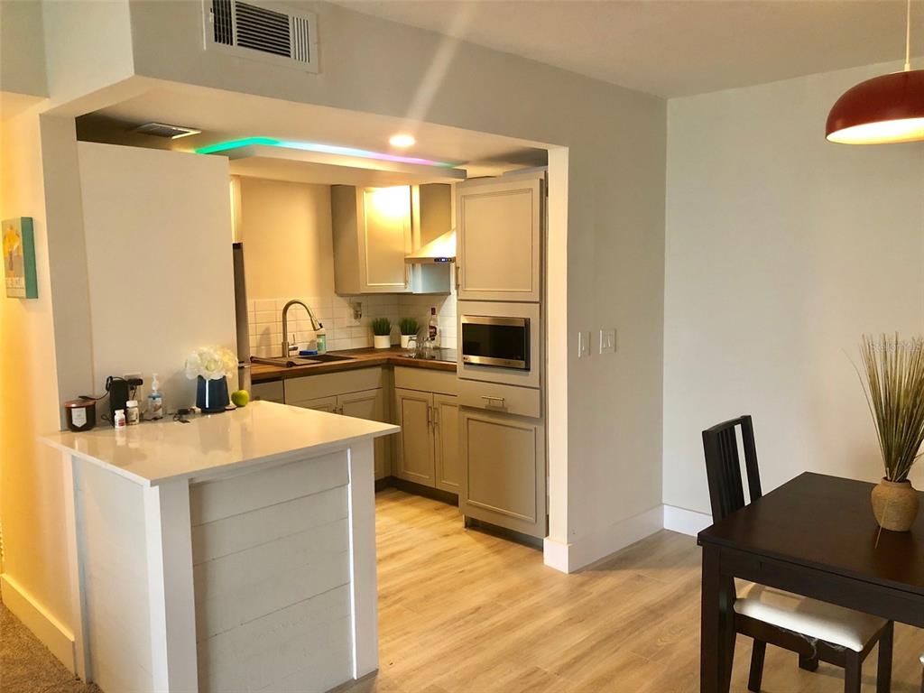 954 Lake Destiny Road, Unit E Altamonte Springs, FL 32714 - Photo 6 of 11 a kitchen with a table chairs refrigerator and cabinets