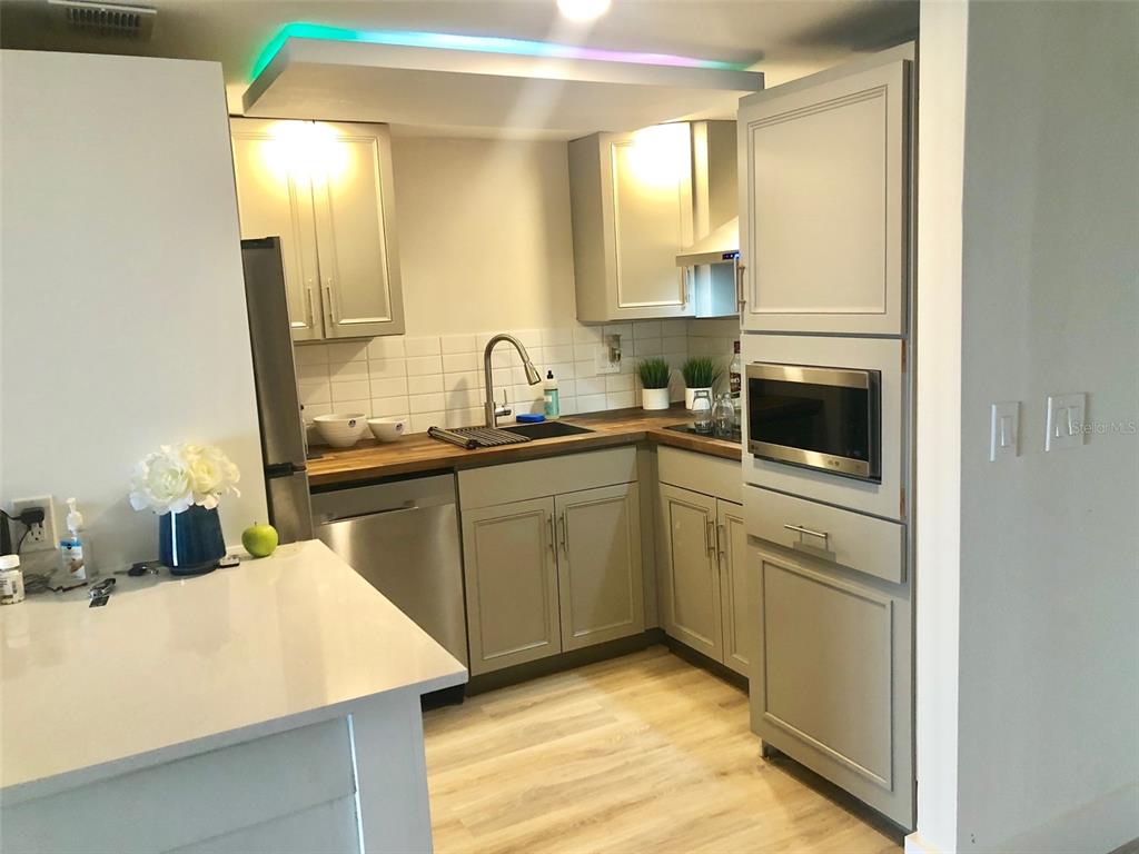 954 Lake Destiny Road, Unit E Altamonte Springs, FL 32714 - Photo 7 of 11 a kitchen with a sink stove and cabinets