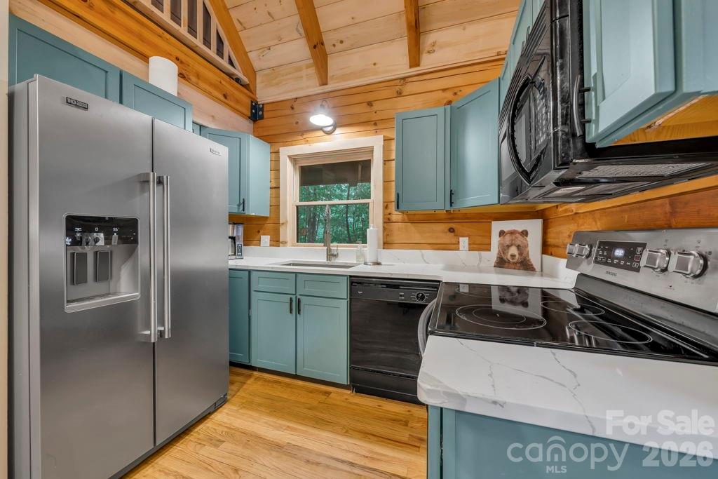 192 Dewitt Barnett Road, Unit 2 Vilas, NC 28692 - Photo 13 of 32 a kitchen with stainless steel appliances granite countertop a refrigerator and a stove