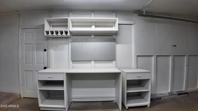 a view of an empty room with a kitchen