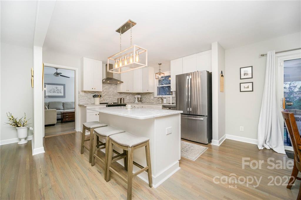 5200 Londonderry Road Charlotte, NC 28210 - Photo 15 of 28 a kitchen with stainless steel appliances a refrigerator a stove a sink dishwasher and white cabinets with wooden floor