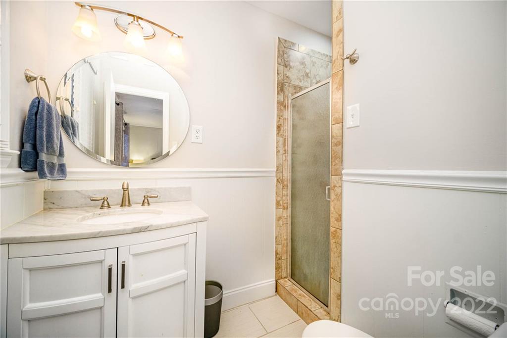 5200 Londonderry Road Charlotte, NC 28210 - Photo 10 of 28 a bathroom with a granite countertop sink and a mirror