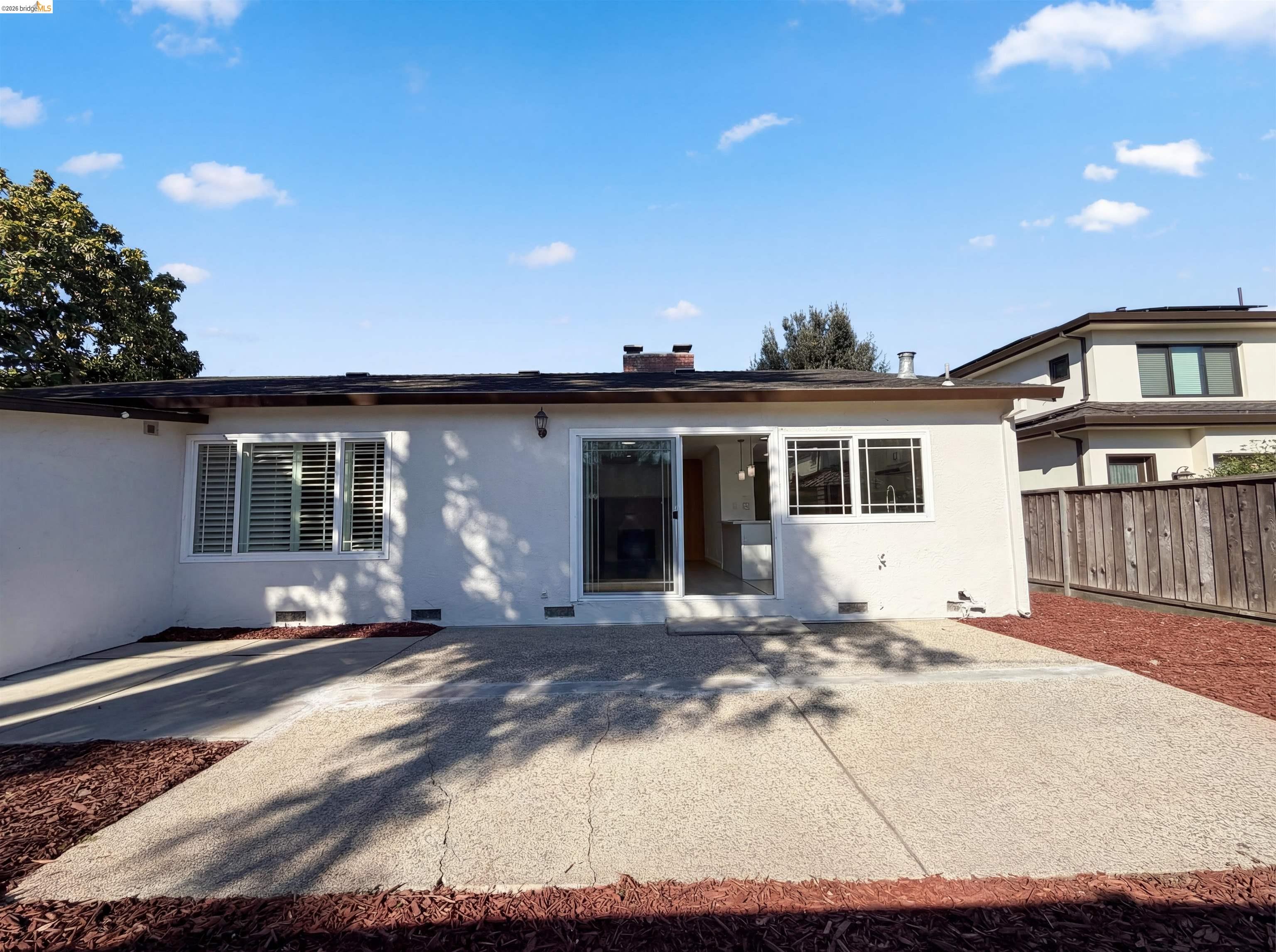 1564 South Wolfe Road Sunnyvale, CA 94087 - Photo 24 of 27 View of front of property featuring stucco siding, a patio area, and a chimney