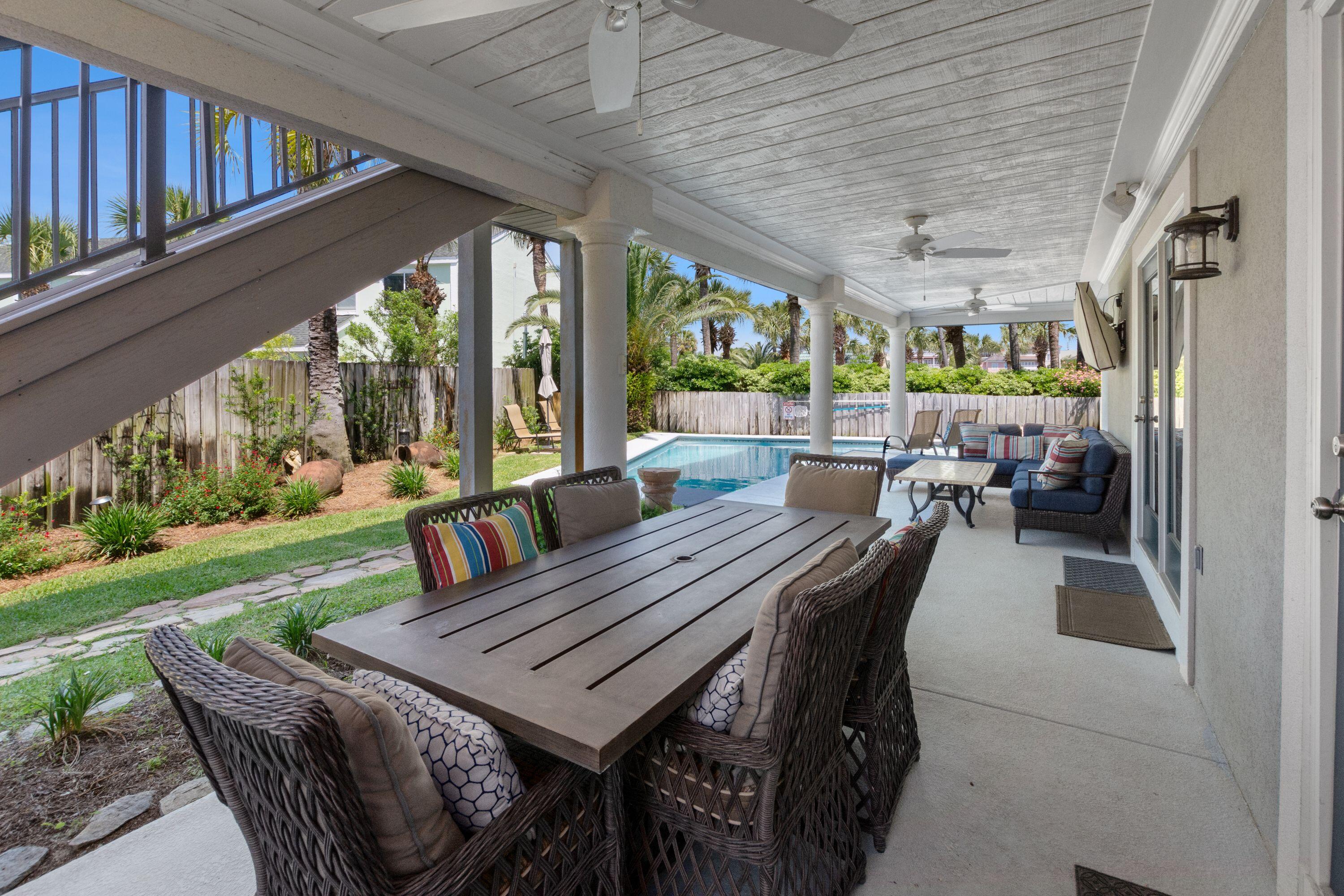 100 Sandprint Circle Destin, FL 32541 - Photo 13 of 62 a view of a patio with a table chairs and a backyard