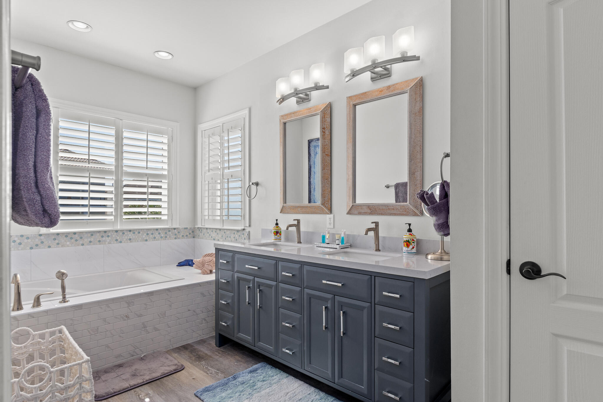 100 Sandprint Circle Destin, FL 32541 - Photo 49 of 62 a bathroom with double vanity sinks a large mirror and a bathtub