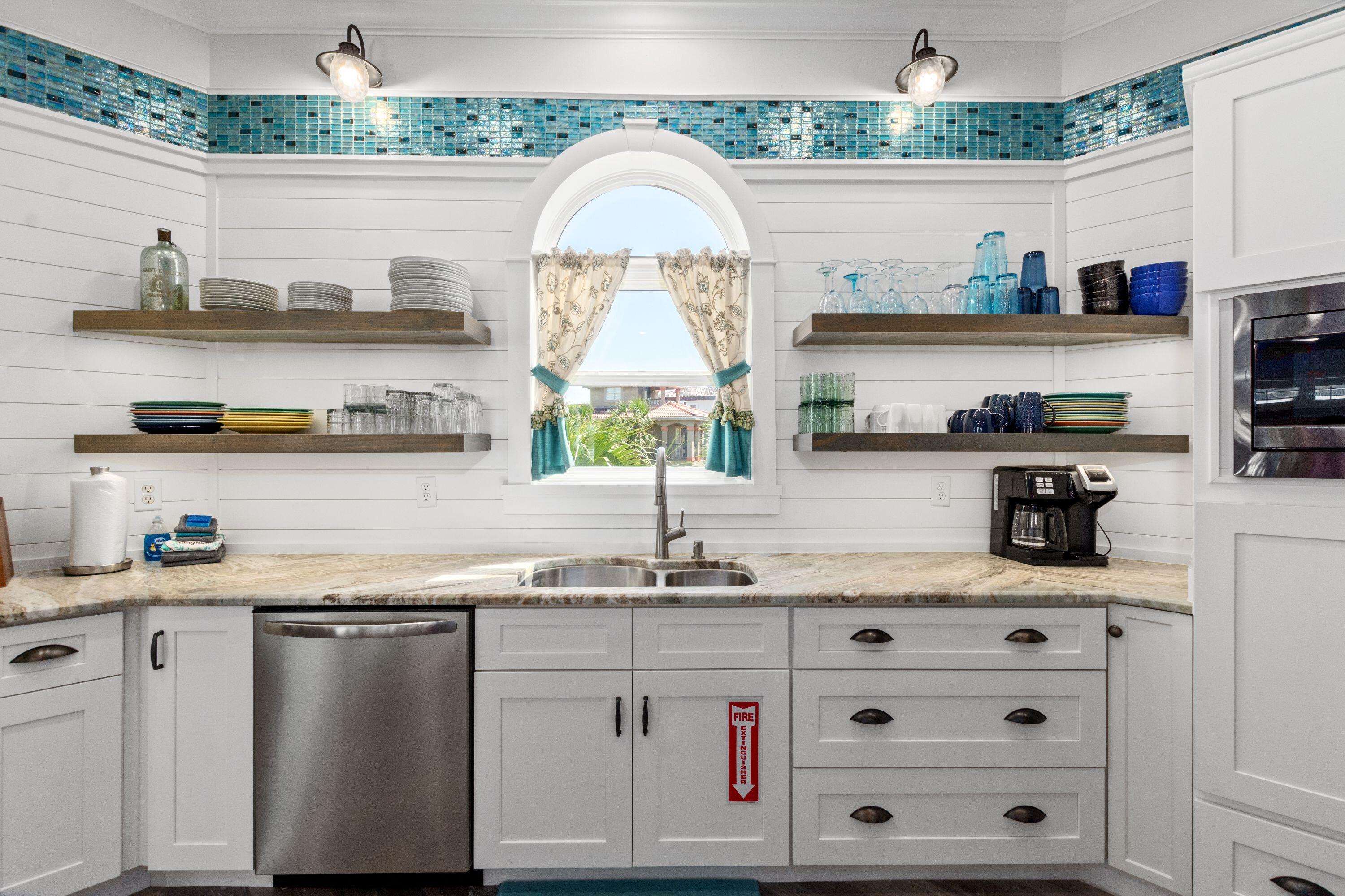 100 Sandprint Circle Destin, FL 32541 - Photo 7 of 62 a kitchen with stainless steel appliances granite countertop a stove a sink and cabinets