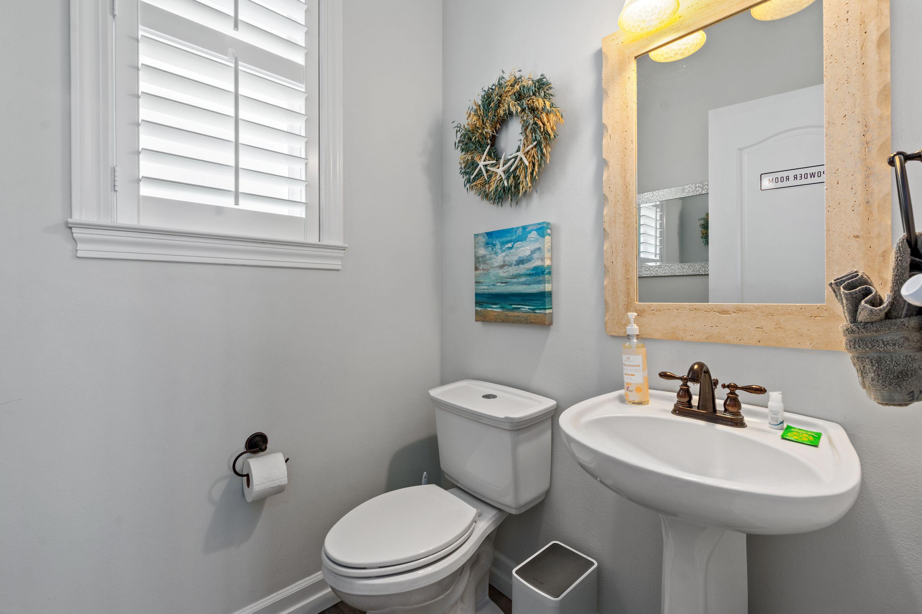 100 Sandprint Circle Destin, FL 32541 - Photo 10 of 62 a bathroom with a toilet sink and mirror