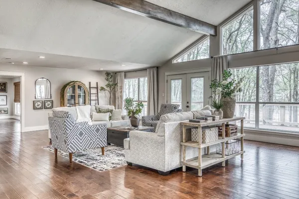 a living room with furniture or wooden floor and a large window