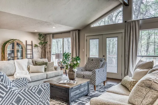 a living room with furniture and a large window
