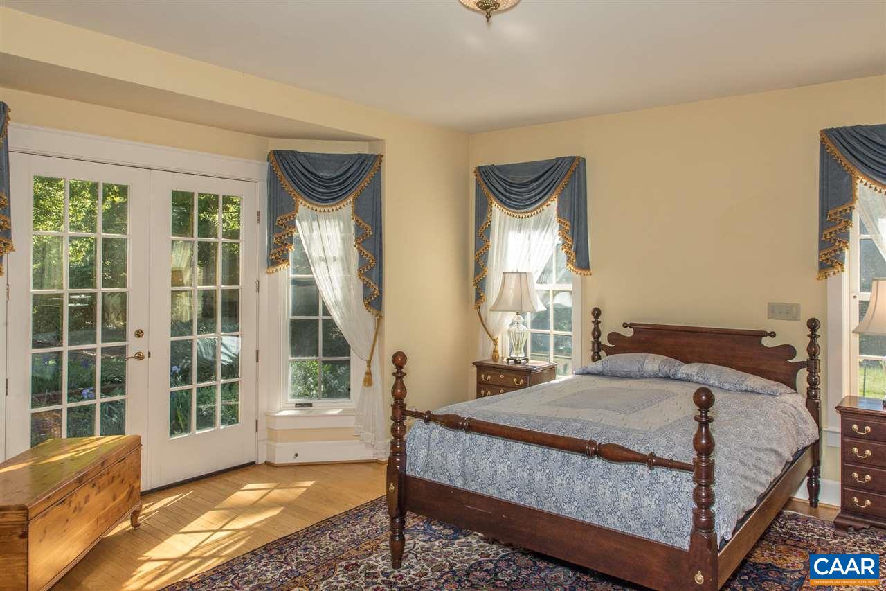 3897 Free Union Road Charlottesville, VA 22901 - Photo 17 of 47 a bedroom with a bed and a large window