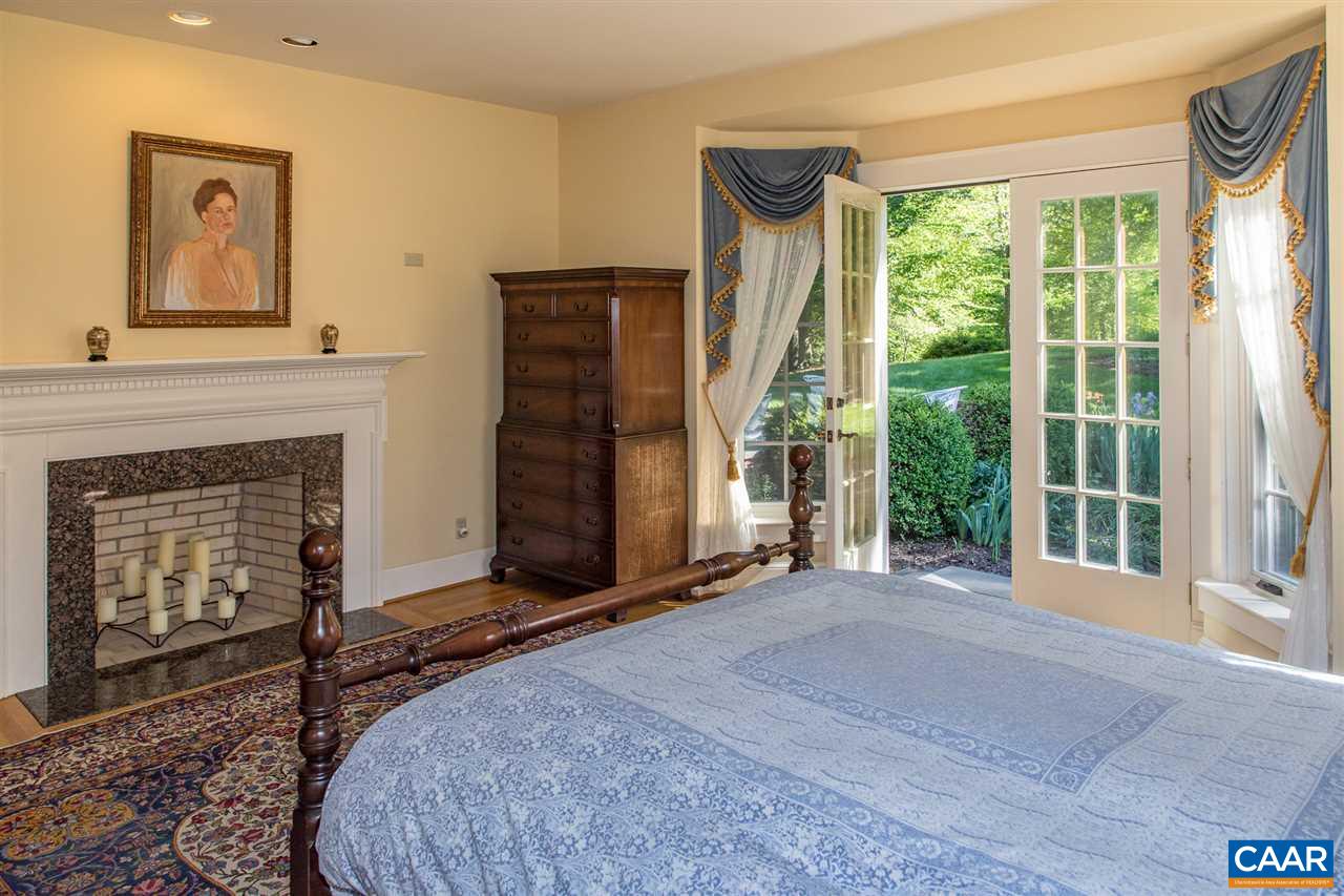 3897 Free Union Road Charlottesville, VA 22901 - Photo 18 of 47 a bed room with a fireplace and a large window