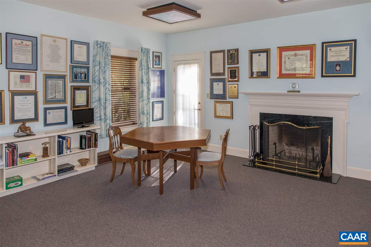 3897 Free Union Road Charlottesville, VA 22901 - Photo 27 of 47 a living room with furniture a fireplace and a book shelf